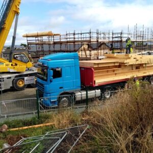 A Truck with wooden beams and a crane at the construction site of the new Wexford Rape Crisis Building